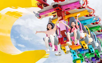 Family enjoying the colorful Big LEGO Coaster at the resort, featuring inverted roller coaster design.