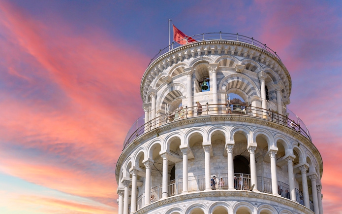 Leaning Tower of Pisa upper levels with sunset sky in Pisa, Italy.