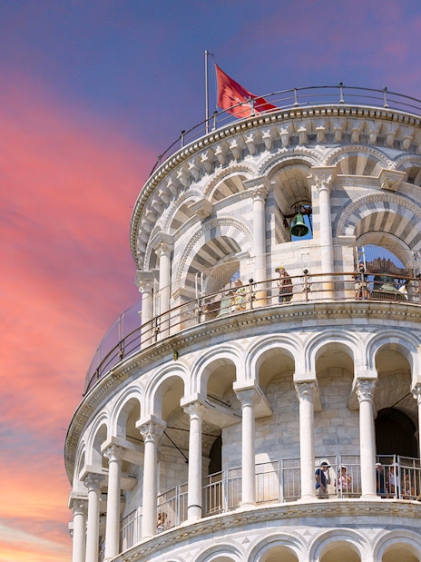 Leaning Tower of Pisa upper levels with sunset sky in Pisa, Italy.
