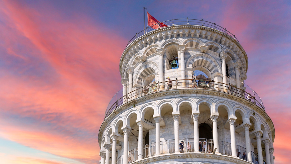 Leaning Tower of Pisa upper levels with sunset sky in Pisa, Italy.