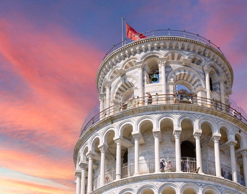 Leaning Tower of Pisa upper levels with sunset sky in Pisa, Italy.