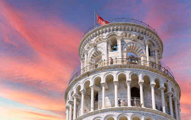 Leaning Tower of Pisa upper levels with sunset sky in Pisa, Italy.