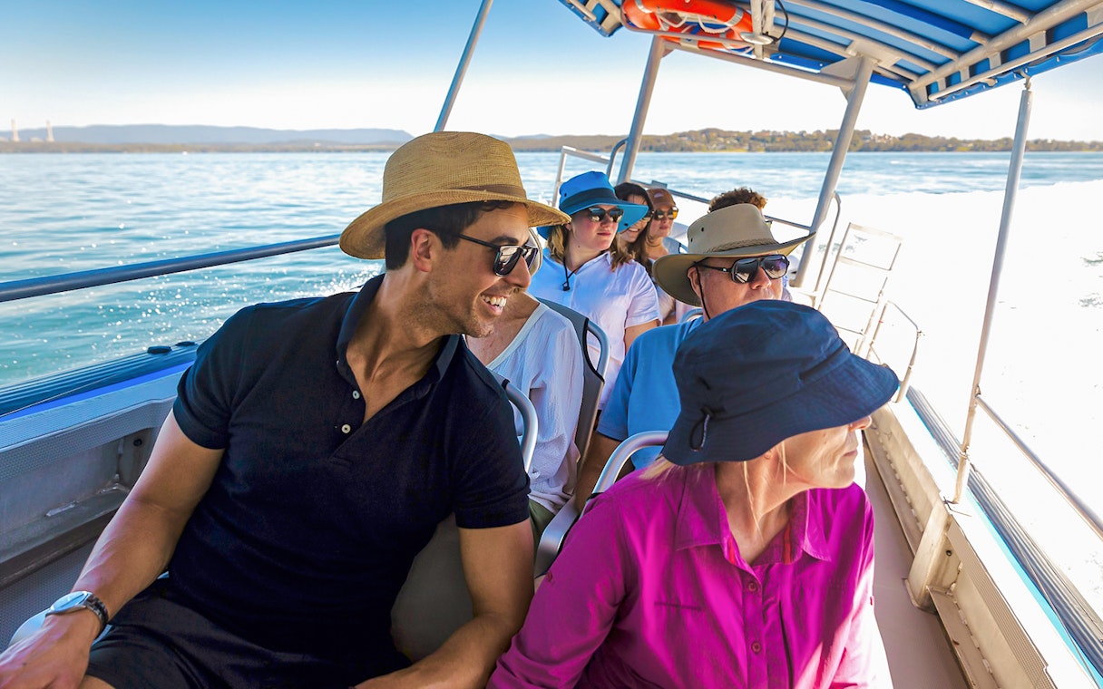 People on a boat enjoying a whale watching tour on Lake Macquarie, Australia.