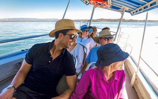 People on a boat enjoying a whale watching tour on Lake Macquarie, Australia.