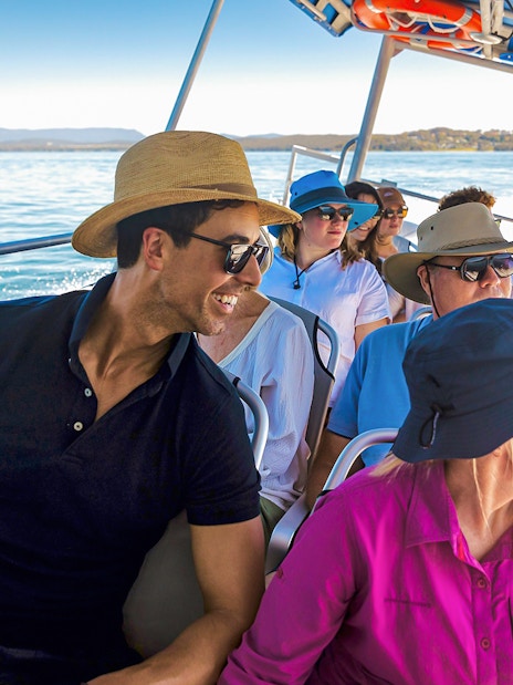 People on a boat enjoying a whale watching tour on Lake Macquarie, Australia.