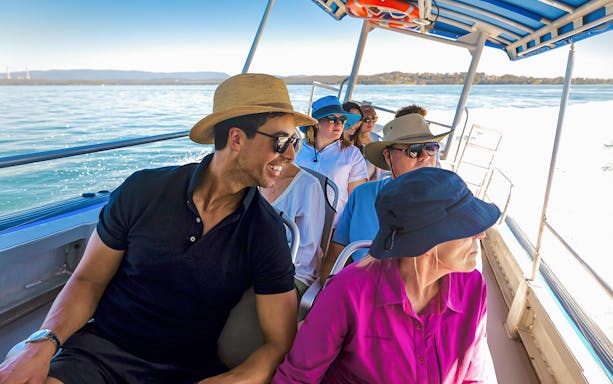 People on a boat enjoying a whale watching tour on Lake Macquarie, Australia.