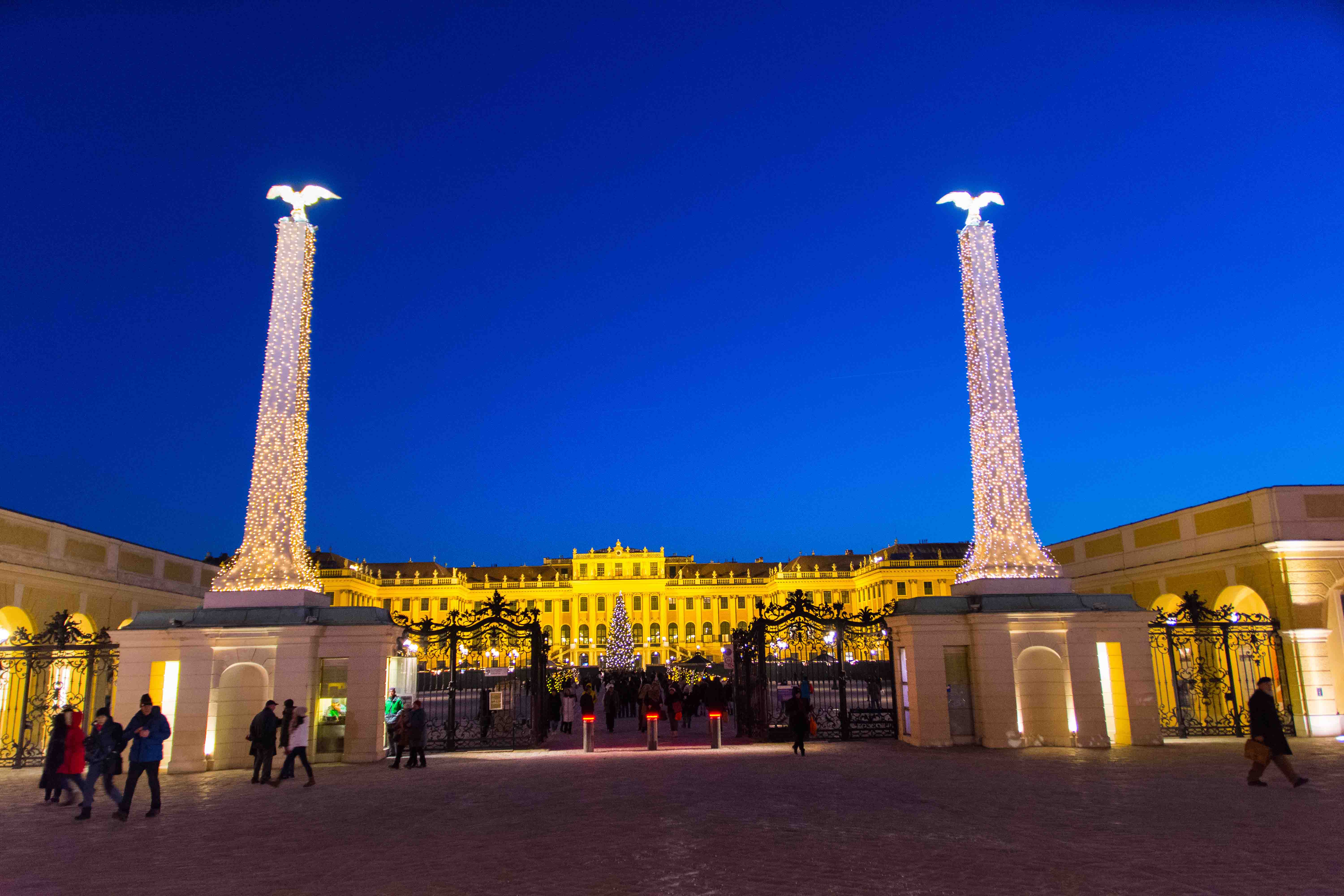 Schonbrunn Palace entrance lit up at night during the Christmas market in Vienna.