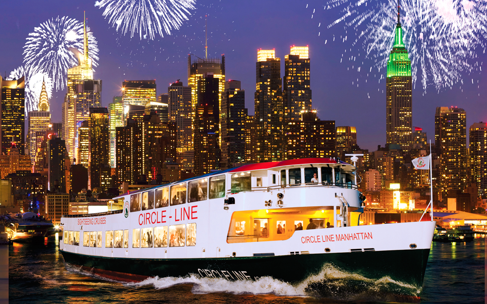 Cruise ship on New Year’s Eve in NYC with fireworks over Manhattan skyline.