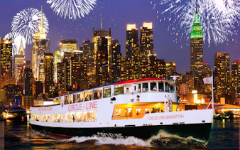 Cruise ship on New Year’s Eve in NYC with fireworks over Manhattan skyline.