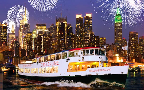 Cruise ship on New Year’s Eve in NYC with fireworks over Manhattan skyline.