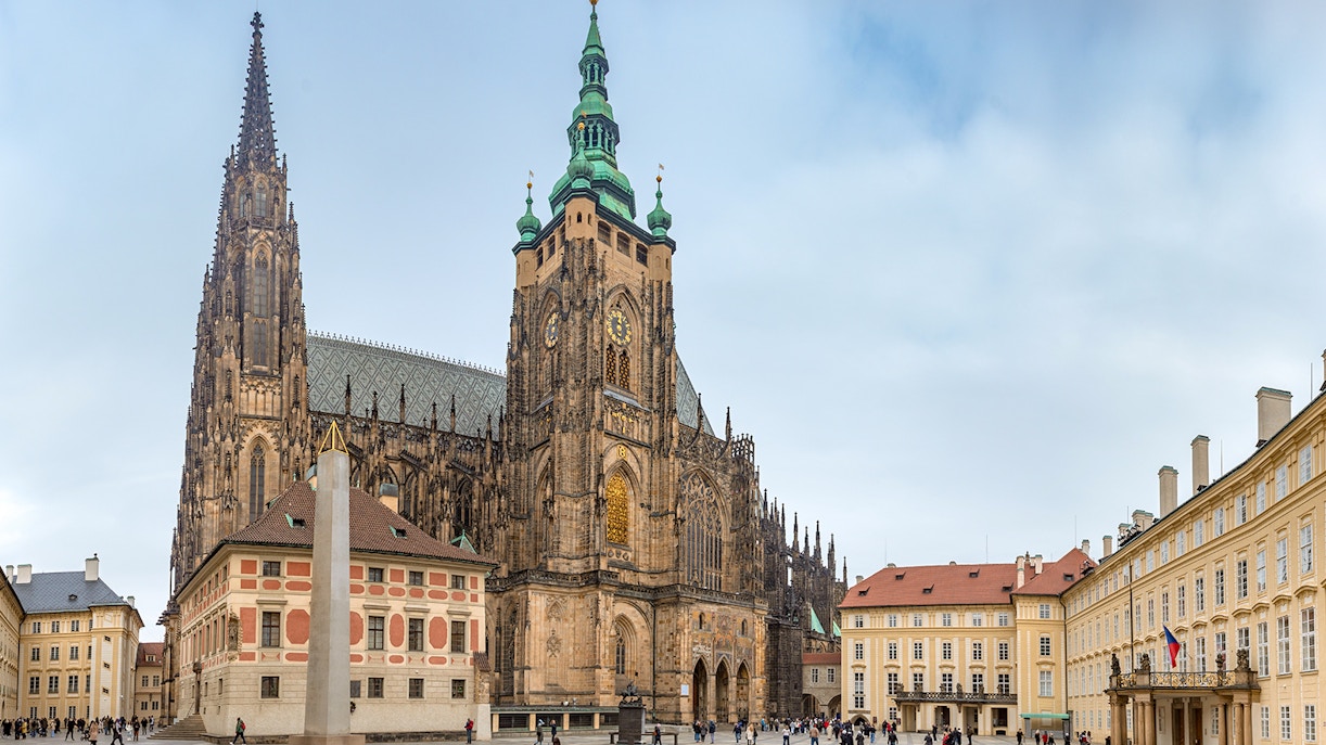 Prague Castle with tourists exploring the historic architecture and gardens.