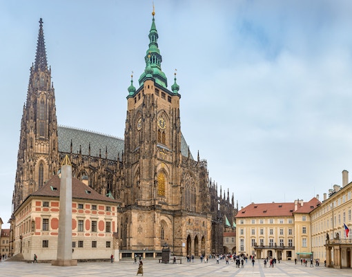 Prague Castle with tourists exploring the historic architecture and gardens.