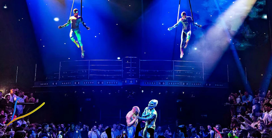 Aerial performers and costumed characters entertain a crowd at Coco Bongo Punta Cana.