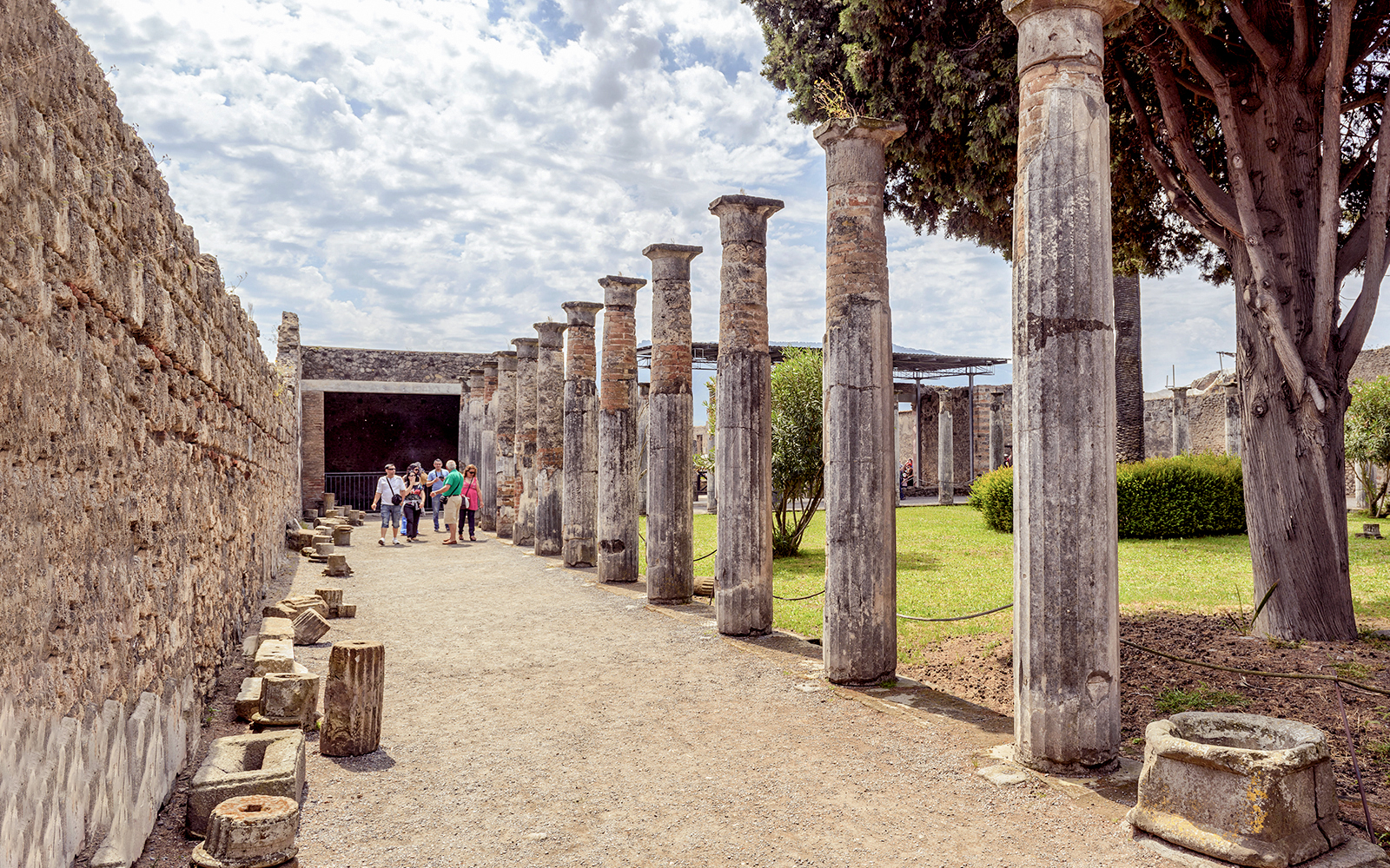 Group exploring ancient columns on a 2-hour private guided tour of Pompeii.