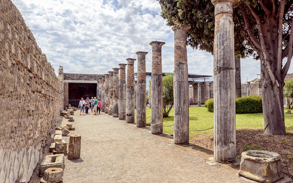 Group exploring ancient columns on a 2-hour private guided tour of Pompeii.