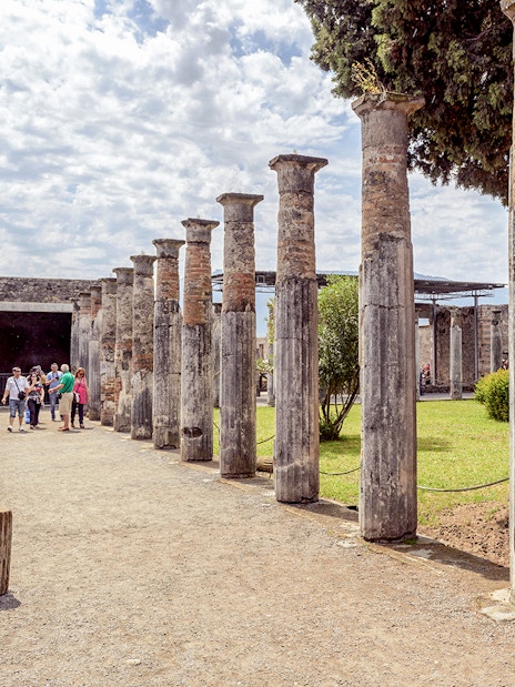 Group exploring ancient columns on a 2-hour private guided tour of Pompeii.