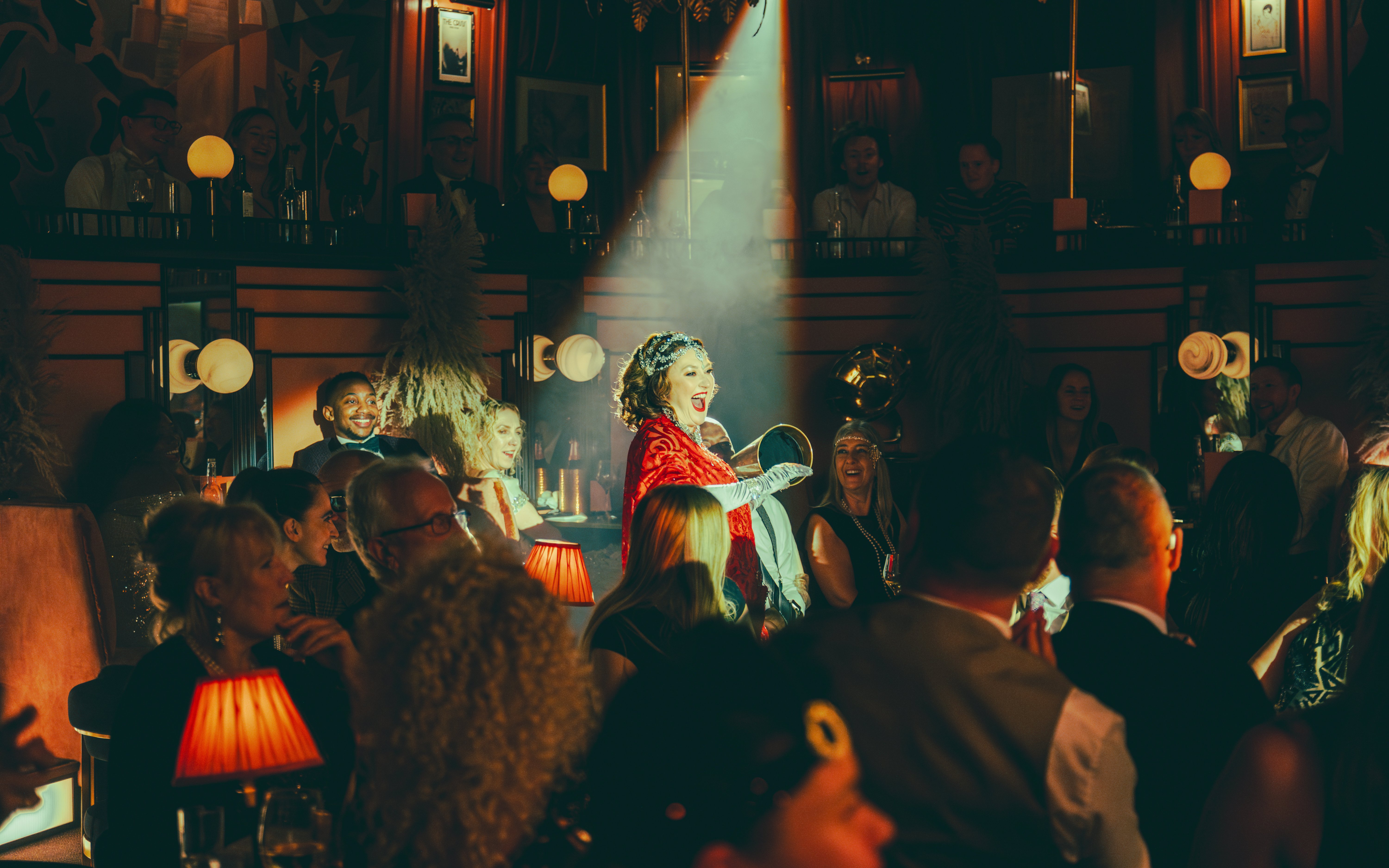 Performer entertaining audience at 58th Street venue with spotlight on stage.