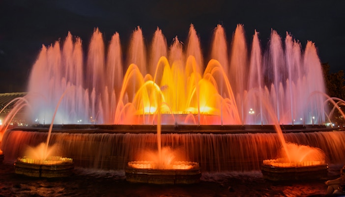 Fountain of Montjuïc illuminated at night in Barcelona, Spain.