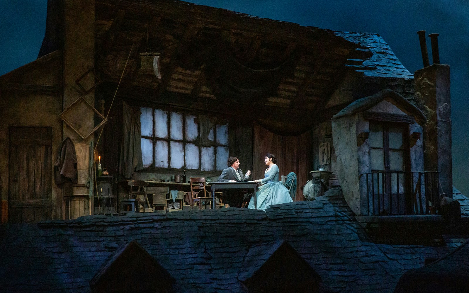 Two characters in a Parisian attic scene from La Bohème opera.