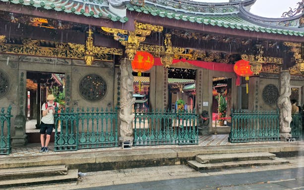 Chinatown temple entrance with red lanterns during Singapore City Tour.