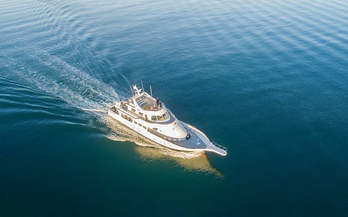 Yacht cruising on open water during Northern Lights tour.