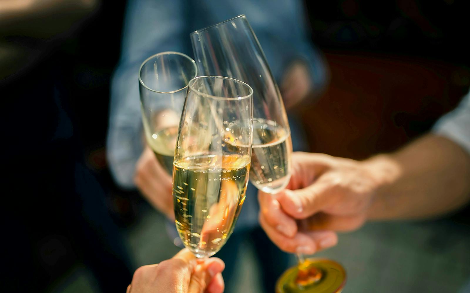 Friends clinking champagne glasses in celebration.