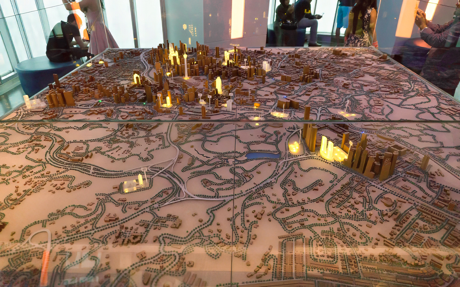 Model of Kuala Lumpur cityscape with illuminated Petronas Twin Towers.