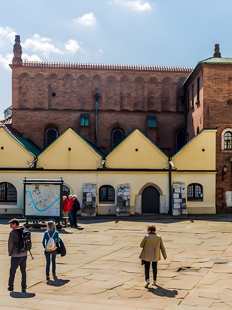 Tourists exploring the historic Jewish Quarter in Kazimierz, Krakow, near Schindler's Factory.