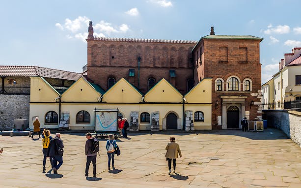 Tourists exploring the historic Jewish Quarter in Kazimierz, Krakow, near Schindler's Factory.