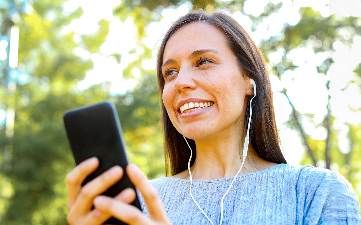 Listening to audioguide at Château of Vaux-le-Vicomte gardens.