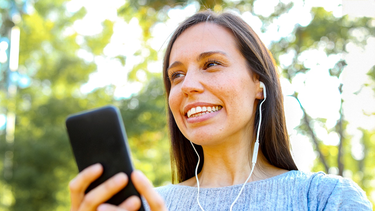 A female tourist using audio guide during Notre Dame Cathedral Audio Tour
