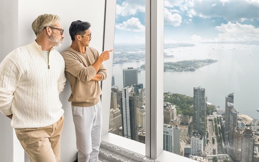 Tourists enjoying 360° views of New York City from One World Observatory.