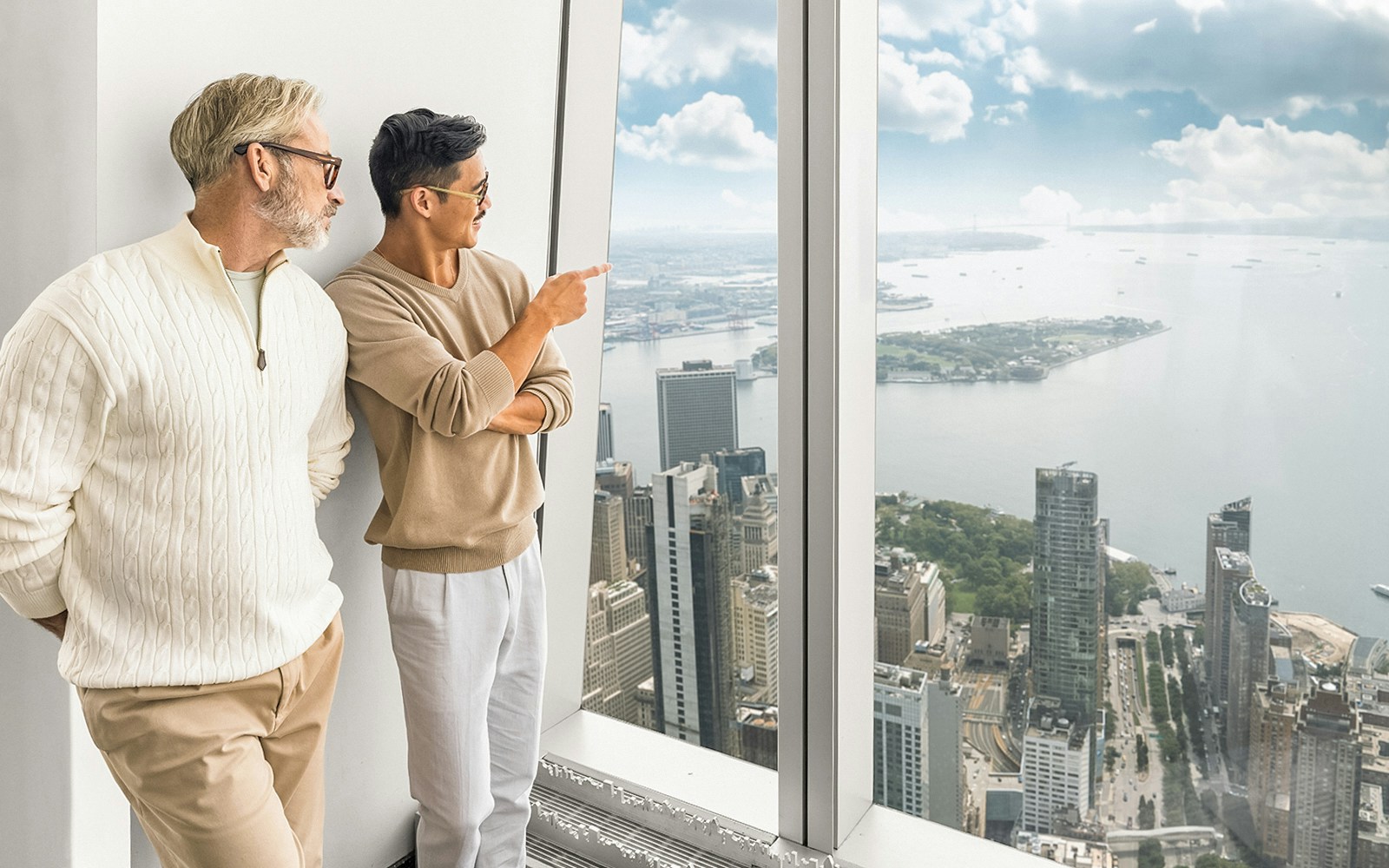 Tourists enjoying 360° views of New York City from One World Observatory.