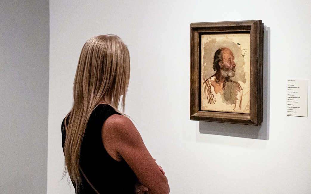 Visitor viewing a Picasso painting at the Picasso Museum during a guided tour.