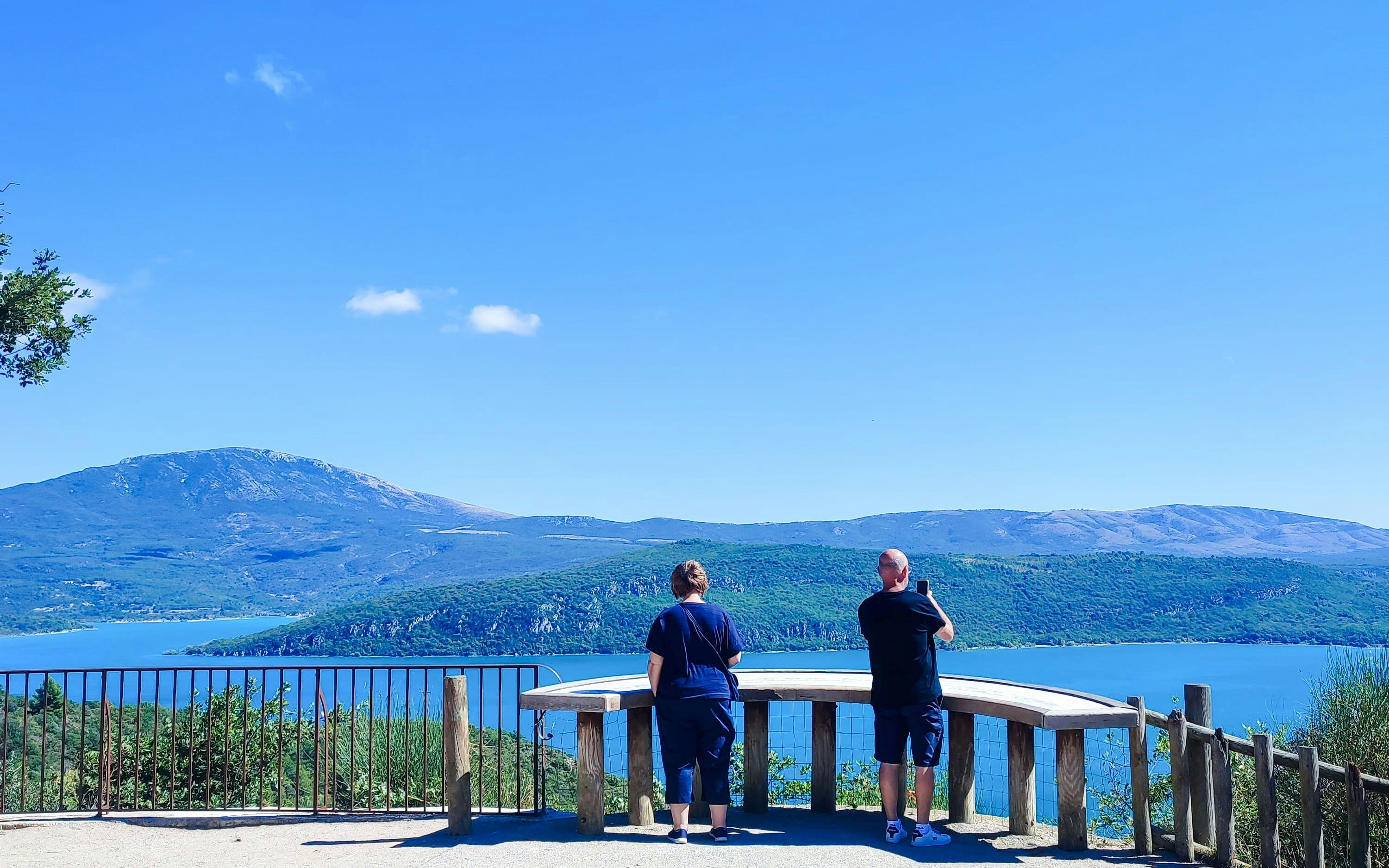 Visitors enjoying the view of Lac de Sainte-Croix near Moustiers-Sainte-Marie, Provence, France.