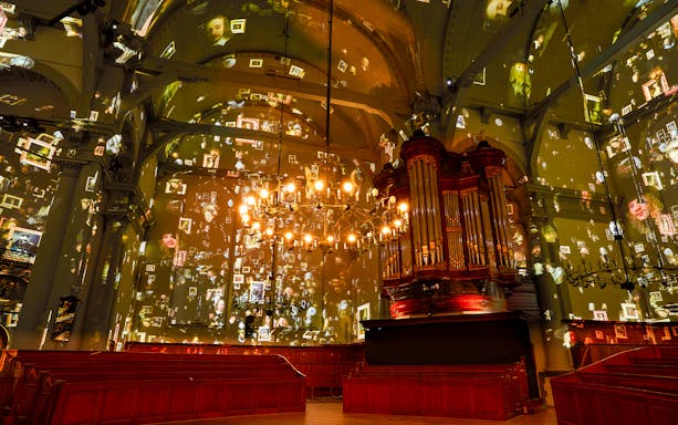 Sound and light projection show featuring Van Gogh and Rembrandt in a historic hall.