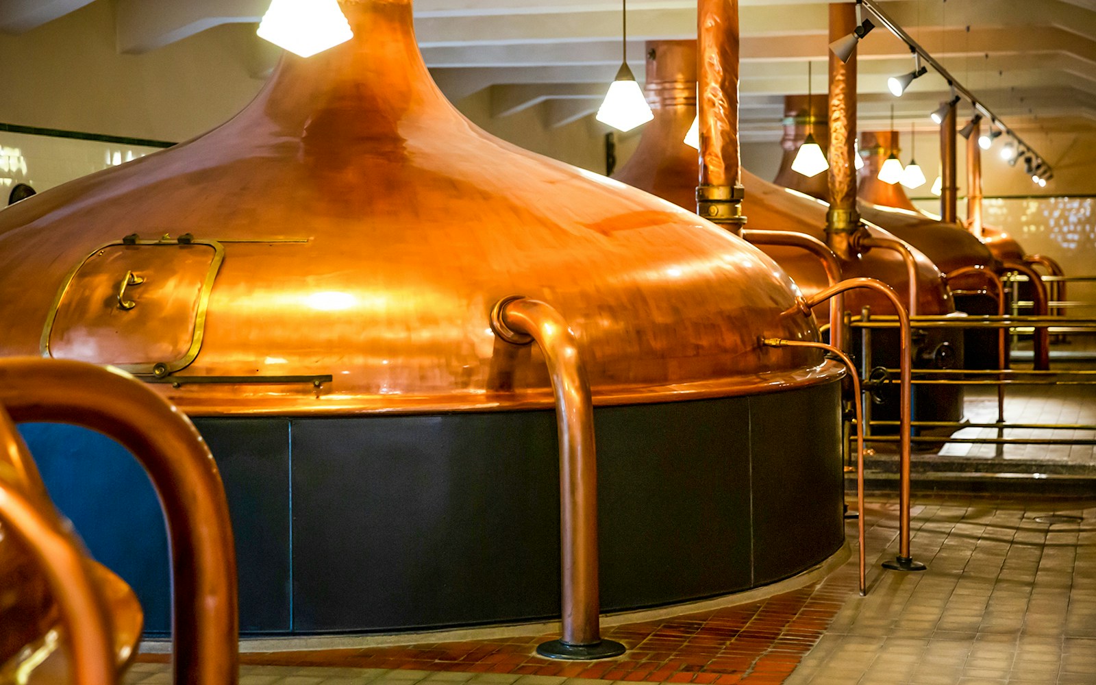 Pilsner Urquell brewery tour showcasing historic copper brewing kettles in Plzeň, Czech Republic.