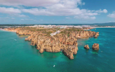 Aerial view of Algarve coastline with cliffs and turquoise waters, Portugal.