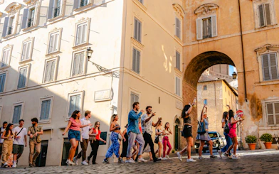 Guests enjoying the Tipsy Tour in Rome, walking through historic streets.
