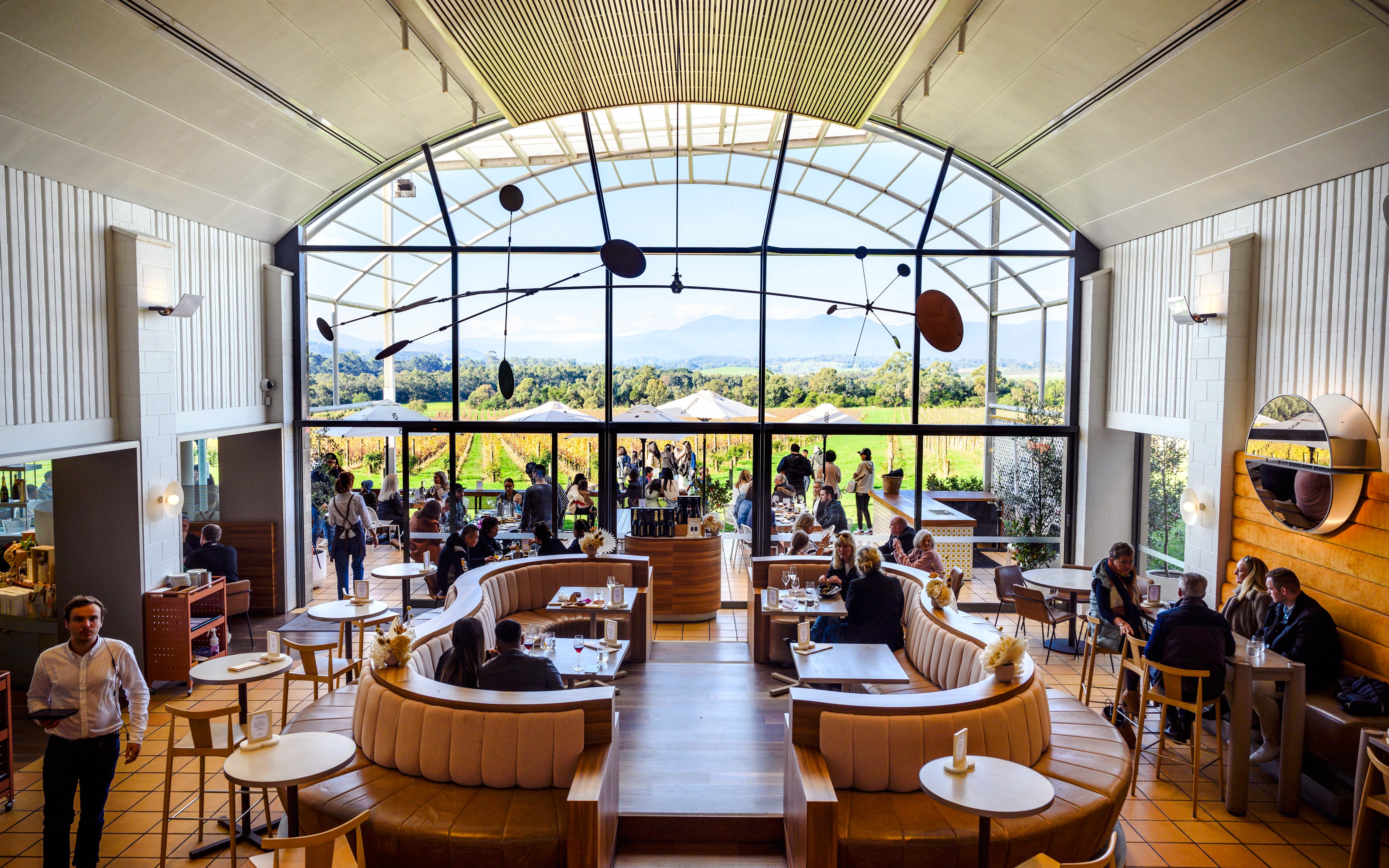 Winery visitors enjoying a meal with vineyard views at Chandon Australia.