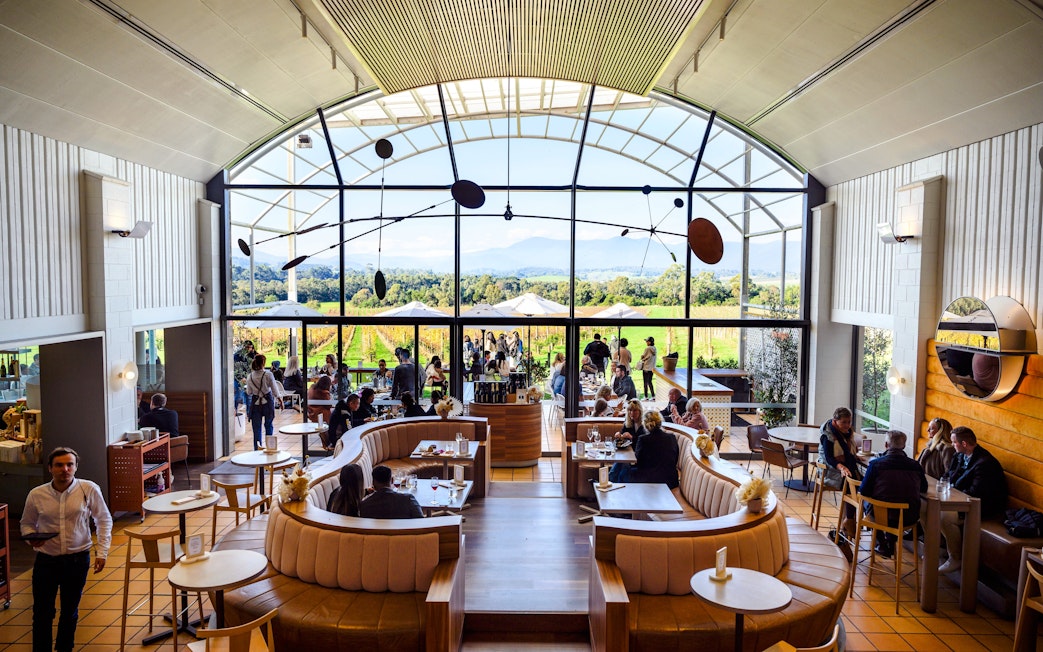 Winery visitors enjoying a meal with vineyard views at Chandon Australia.