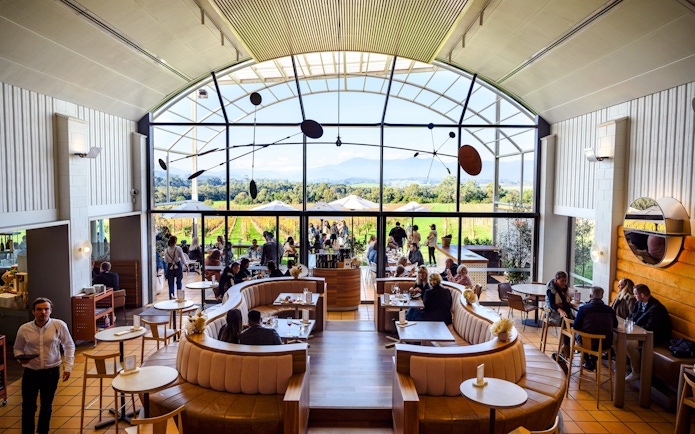 Winery visitors enjoying a meal with vineyard views at Chandon Australia.
