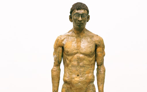 Sculpture of a standing man with glasses at Palazzo Strozzi's "Reaching for the Stars" exhibition.
