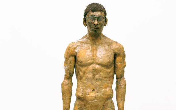 Sculpture of a standing man with glasses at Palazzo Strozzi's "Reaching for the Stars" exhibition.