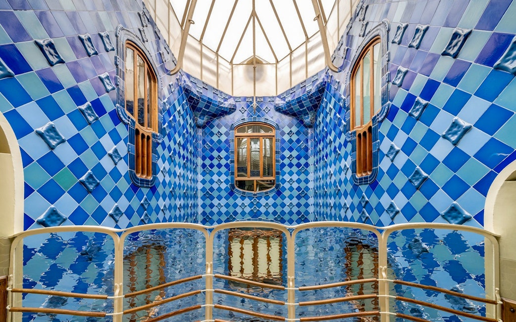 Casa Batlló interior with blue tiled walls and wooden windows, Barcelona.