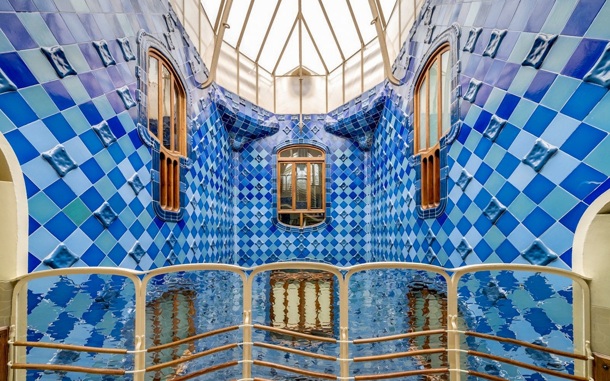Casa Batlló interior with blue tiled walls and wooden windows, Barcelona.