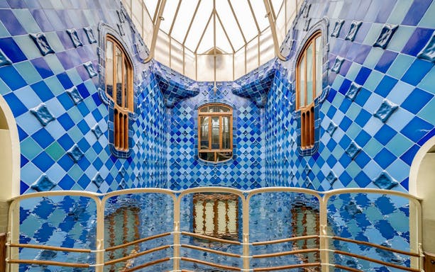 Casa Batlló interior with blue tiled walls and wooden windows, Barcelona.