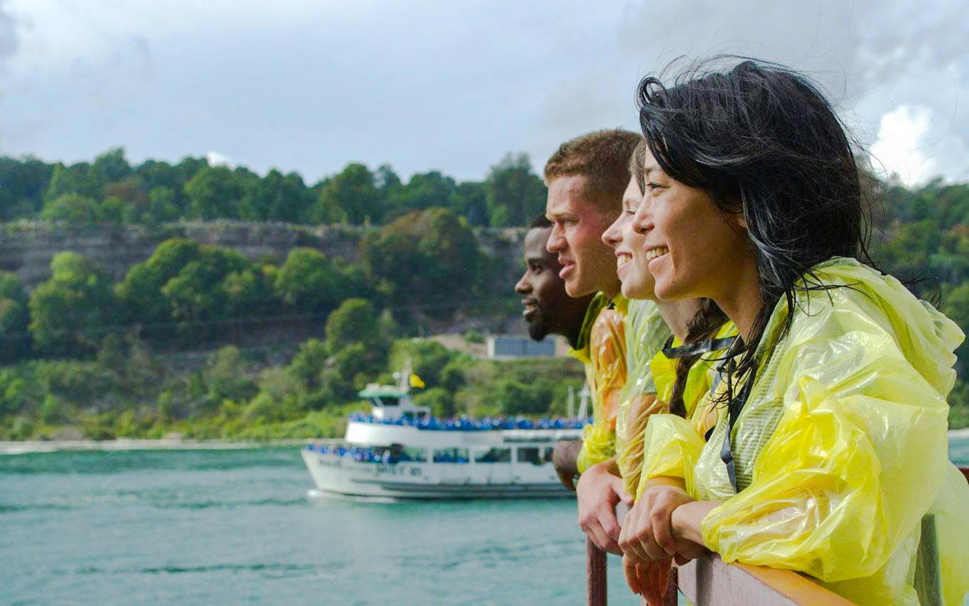 Visitors in yellow ponchos on Maid of the Mist boat tour at Niagara Falls USA.