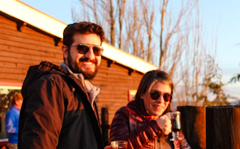 People enjoying drinks at sunset near the Andes Mountains, Santiago.