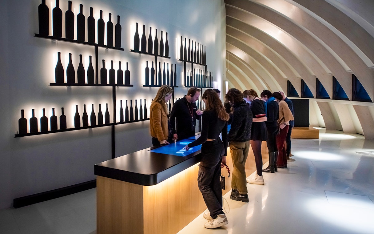 Visitors using interactive displays at Cité du Vin museum, Bordeaux, France.